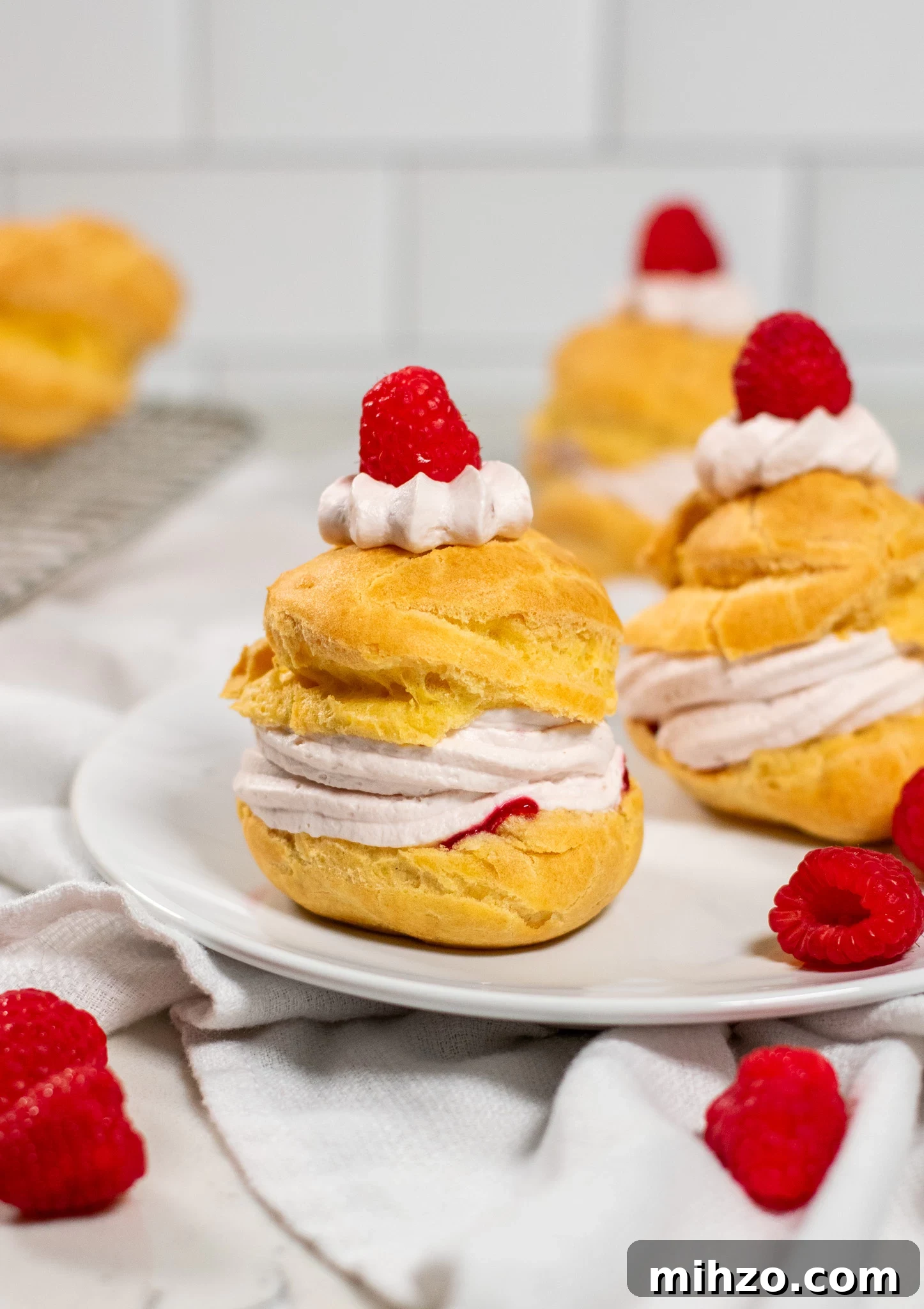 Raspberry Choux Pastry Fastelavnsboller Recipe 5 A choux pastry bun filled with raspberry cream cheese whipped cream and raspberry jam.