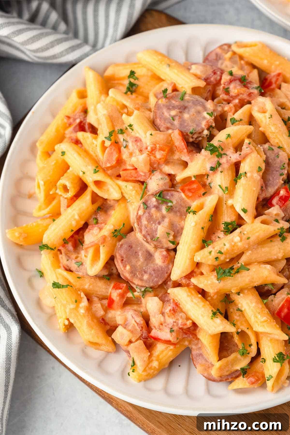 Creamy Kielbasa and Smoked Sausage Pasta Skillet Recipe 2 Creamy kielbasa pasta with diced onion and bell peppers.
