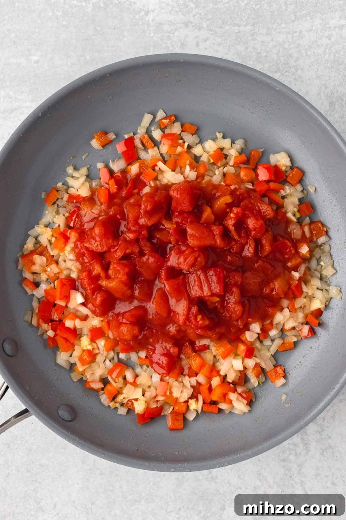 Creamy Kielbasa and Smoked Sausage Pasta Skillet Recipe 6 Diced tomatoes with their juice are added to the large skillet with the cooked veggies.