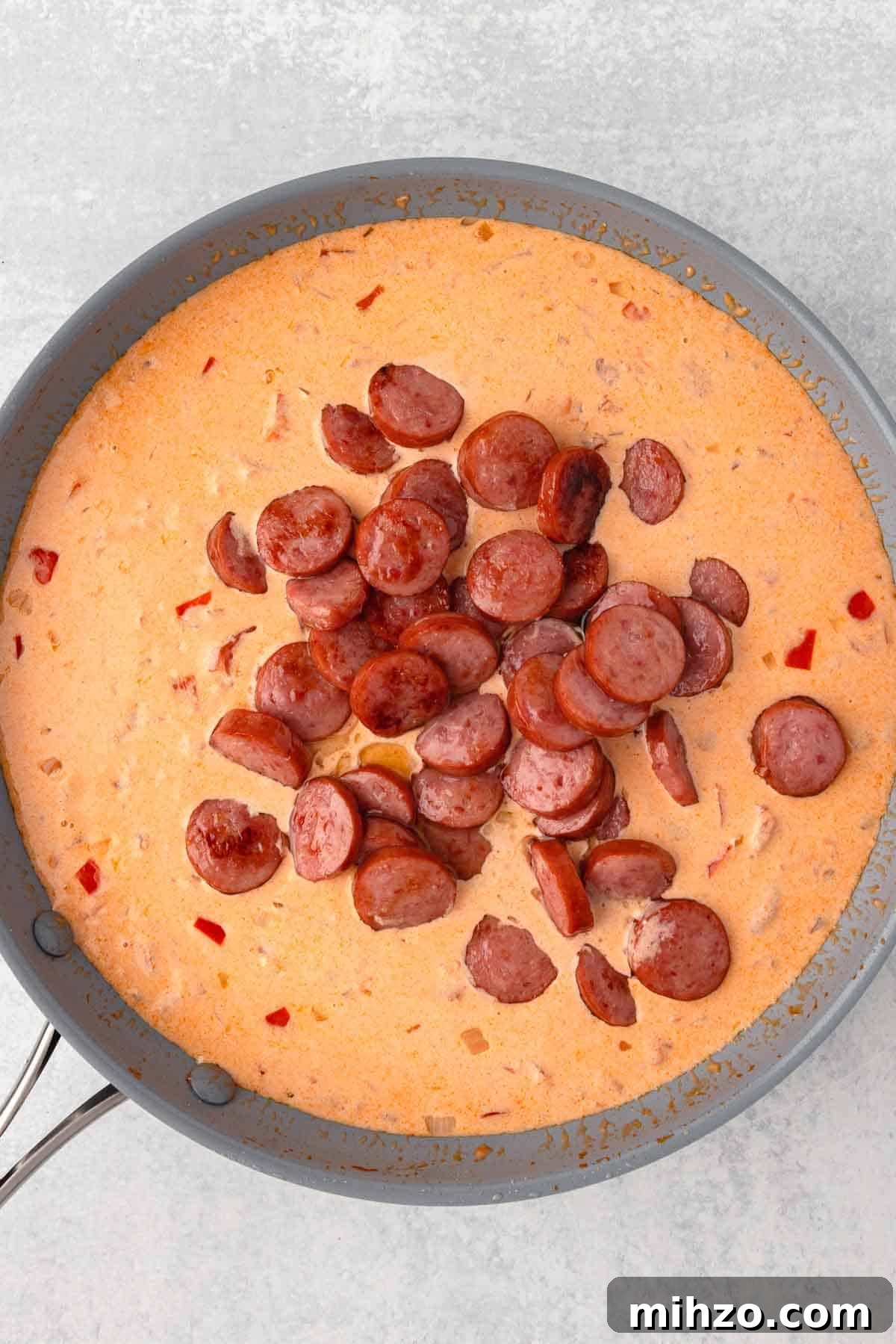 Creamy Kielbasa and Smoked Sausage Pasta Skillet Recipe 8 The cooked slices of kielbasa are added back to the skillet with the sauce.