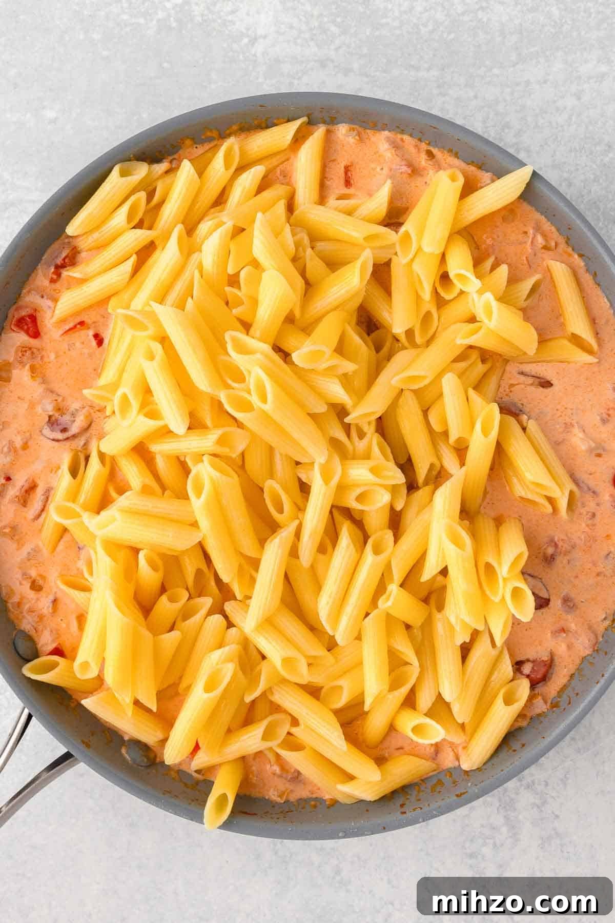 Creamy Kielbasa and Smoked Sausage Pasta Skillet Recipe 9 Cooked pasta is added back to the skillet with the sausage and sauce.