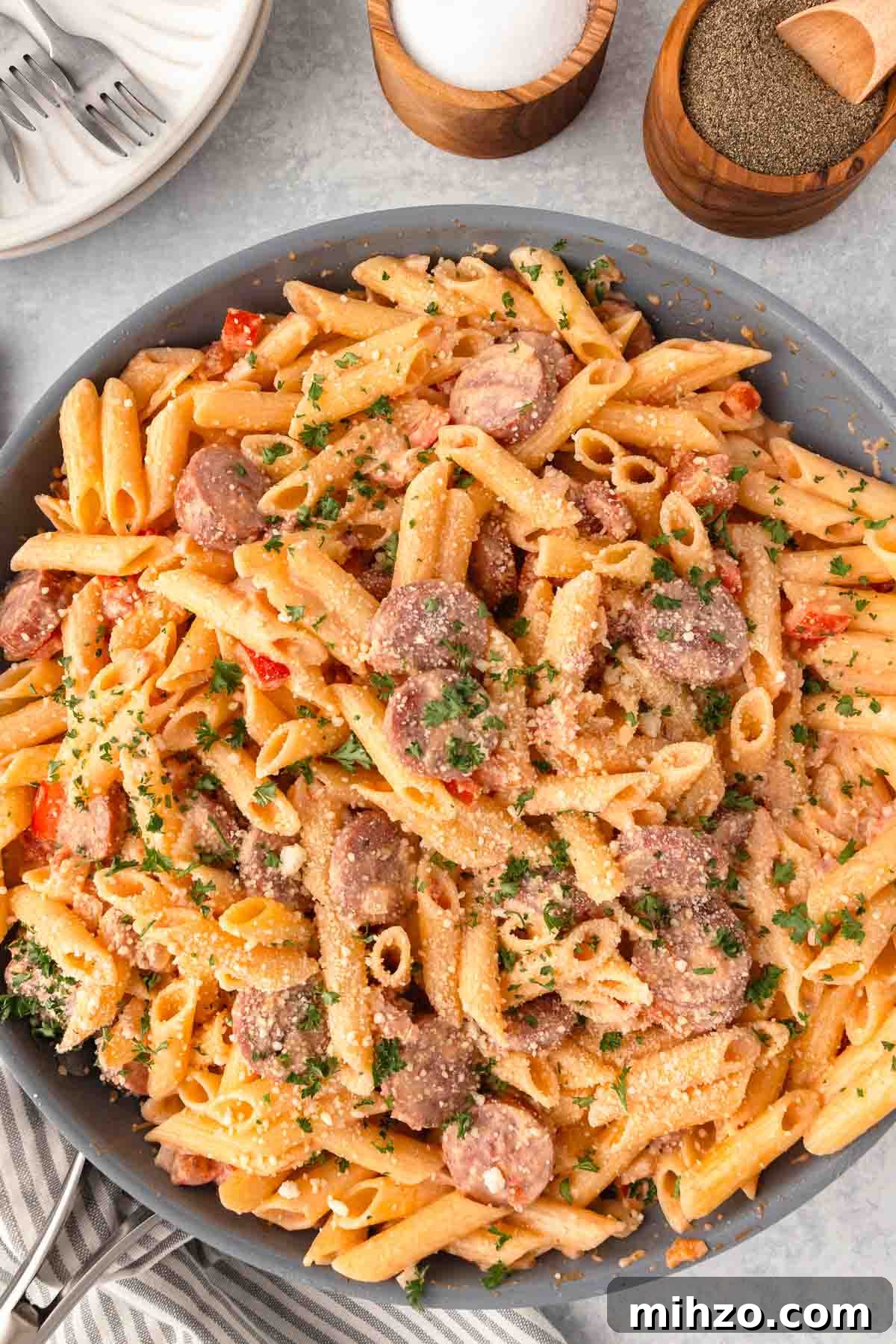Creamy Kielbasa and Smoked Sausage Pasta Skillet Recipe 10 Kielbasa pasta with penne, diced pepper, sliced smoked sausage, parmesan, and a cream sauce in a large skillet.