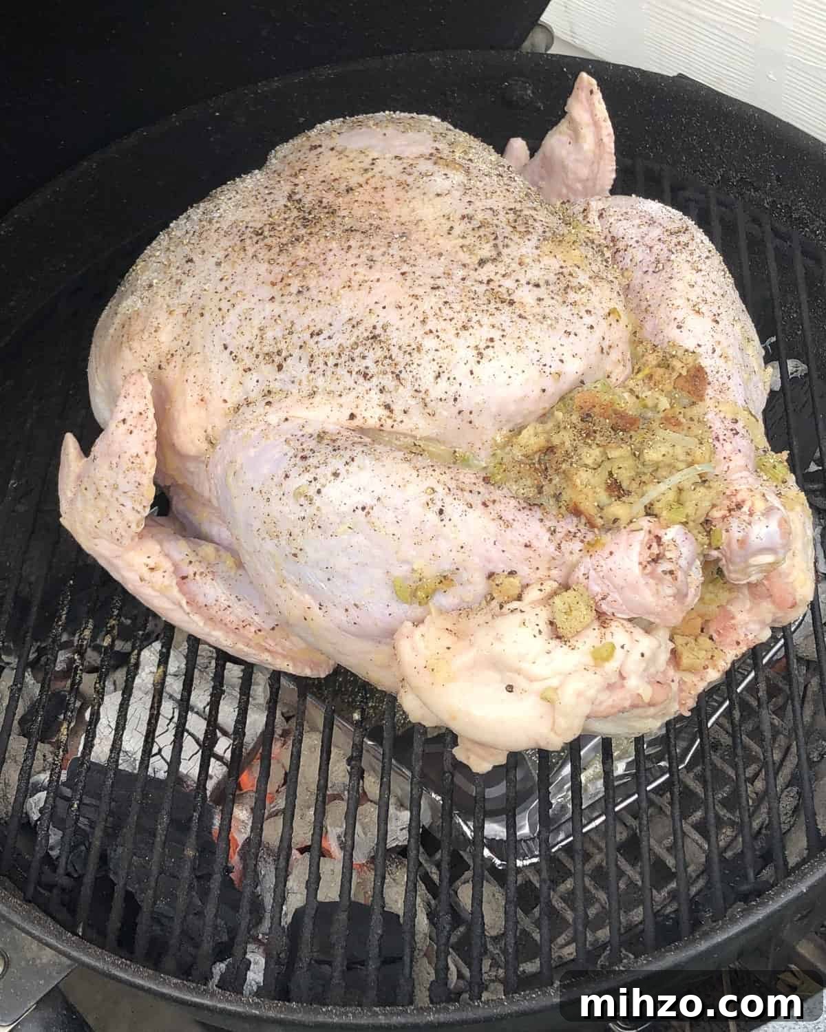 Grilling a Whole Turkey on Charcoal or Gas: Step-by-Step Guide 4 turkey with stuffing on a hot charcoal grill.
