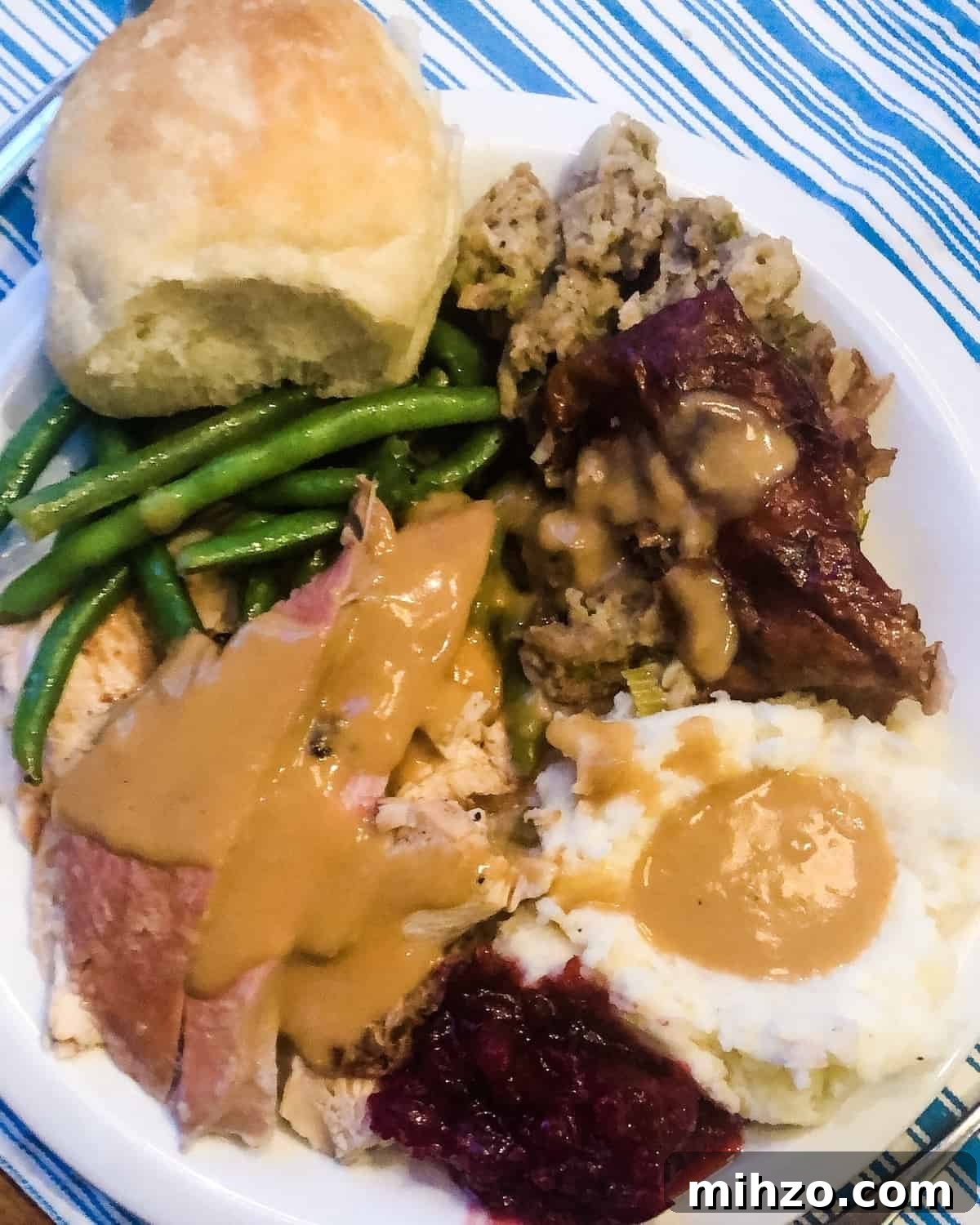 Grilling a Whole Turkey on Charcoal or Gas: Step-by-Step Guide 6 plate of mashed potatoes, grilled turkey, cranberry sauce, green beans and dinner roll