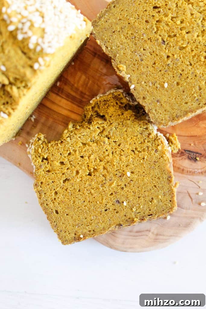 Sliceable Chia Seed Bread for Gluten-Free Toasts & Sandwiches 10 slice of chia seed bread on a cutting board.