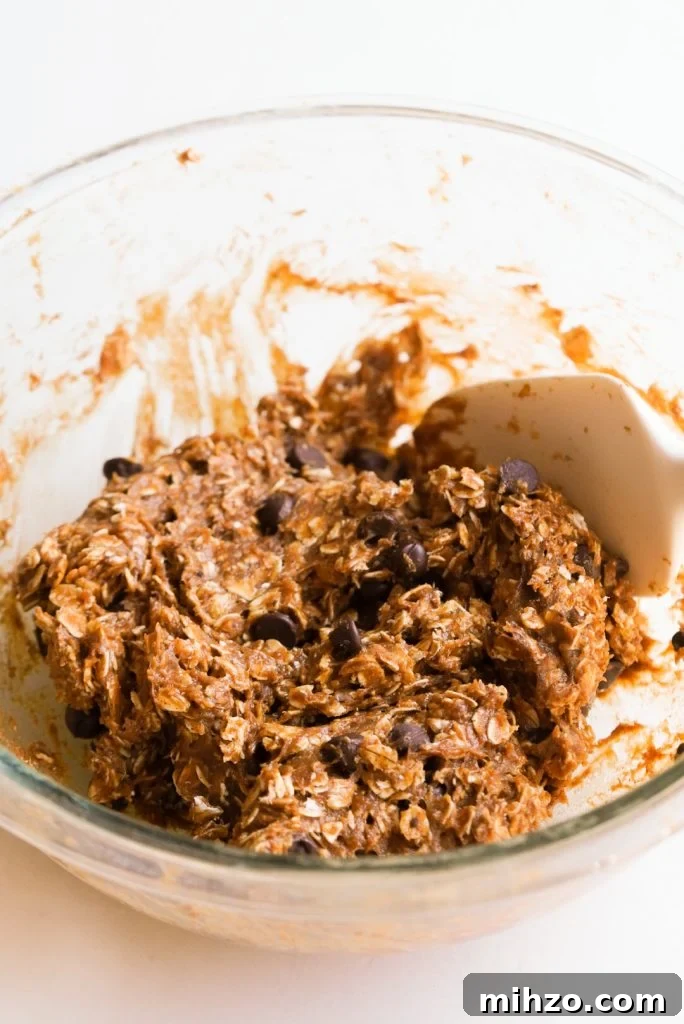 Pumpkin Spice Protein Bites — No-Bake Autumn Snack 7 protein ball mixture with chocolate chips in a mixing bowl