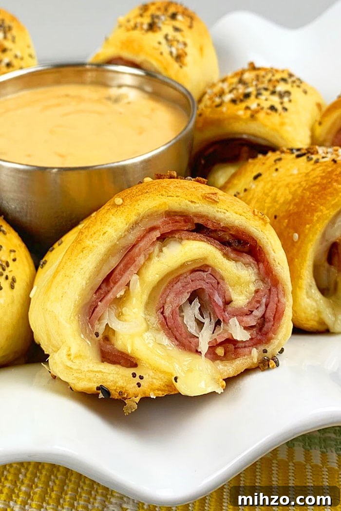 One-Pan Reuben Roll-Ups: Quick Stovetop Sandwich Bites 2 Closeup Shot of Beef Roll Ups on White Plate