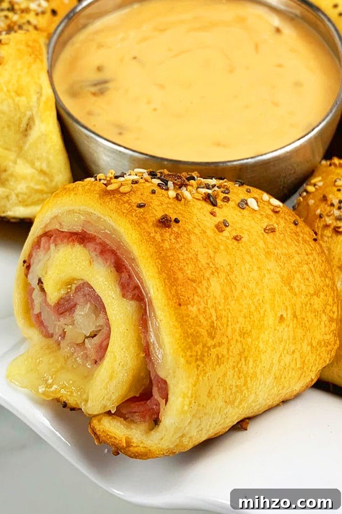 One-Pan Reuben Roll-Ups: Quick Stovetop Sandwich Bites 6 Reuben Roll Ups on White Plate- Closeup Shot