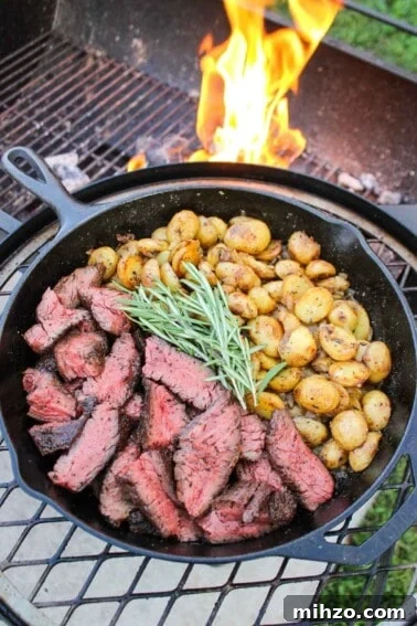The Grilled Steak with Skillet Potatoes served in a cast iron pan.