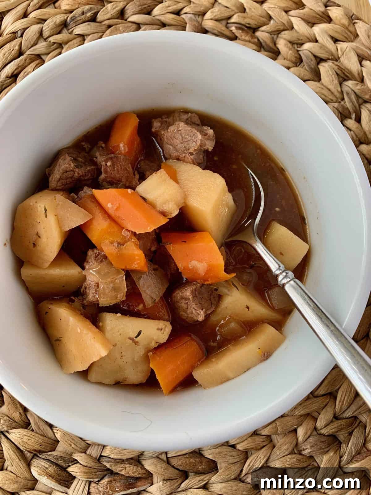 Classic Irish Beef Stew Recipe for Tender, Rich Flavor 5 Irish stew in a small bowl with a spoon.