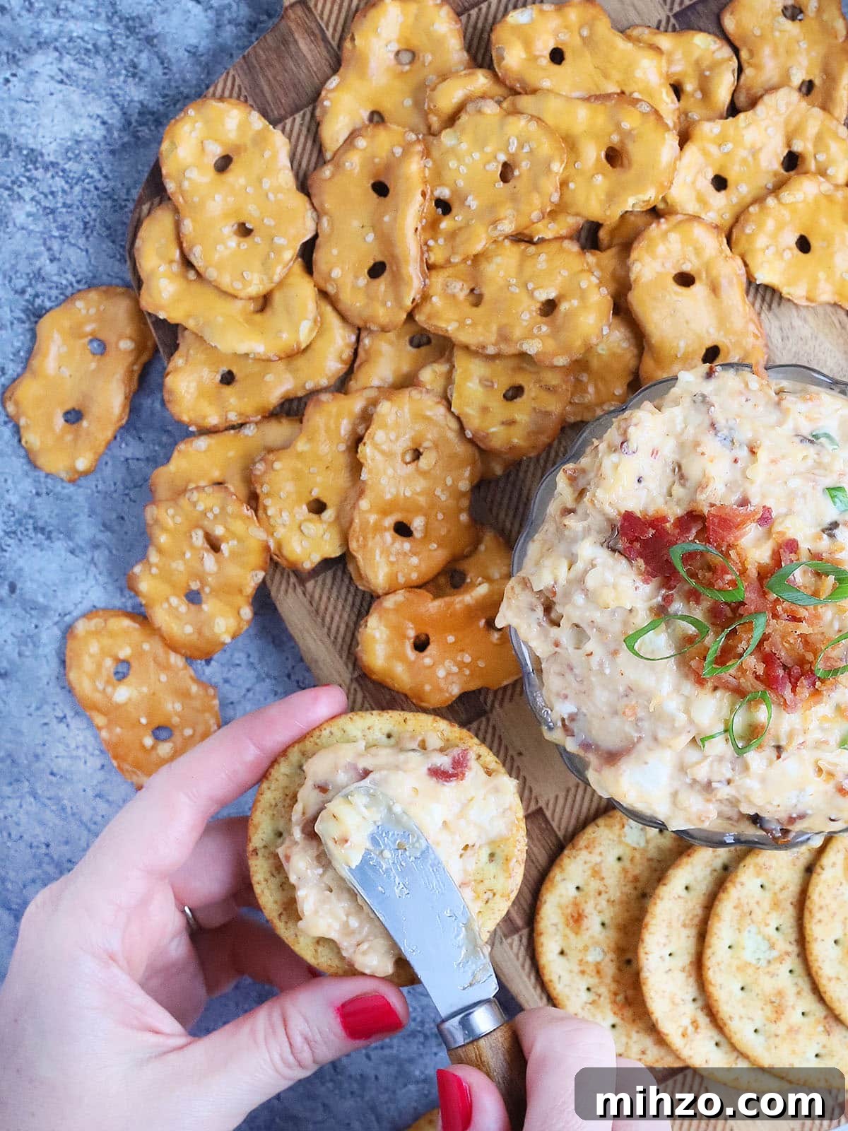 Smoky Chipotle Pimento Cheese Spread with a Spicy Kick 6 Pair of hands spreading spicy pimento cheese onto a cracker.