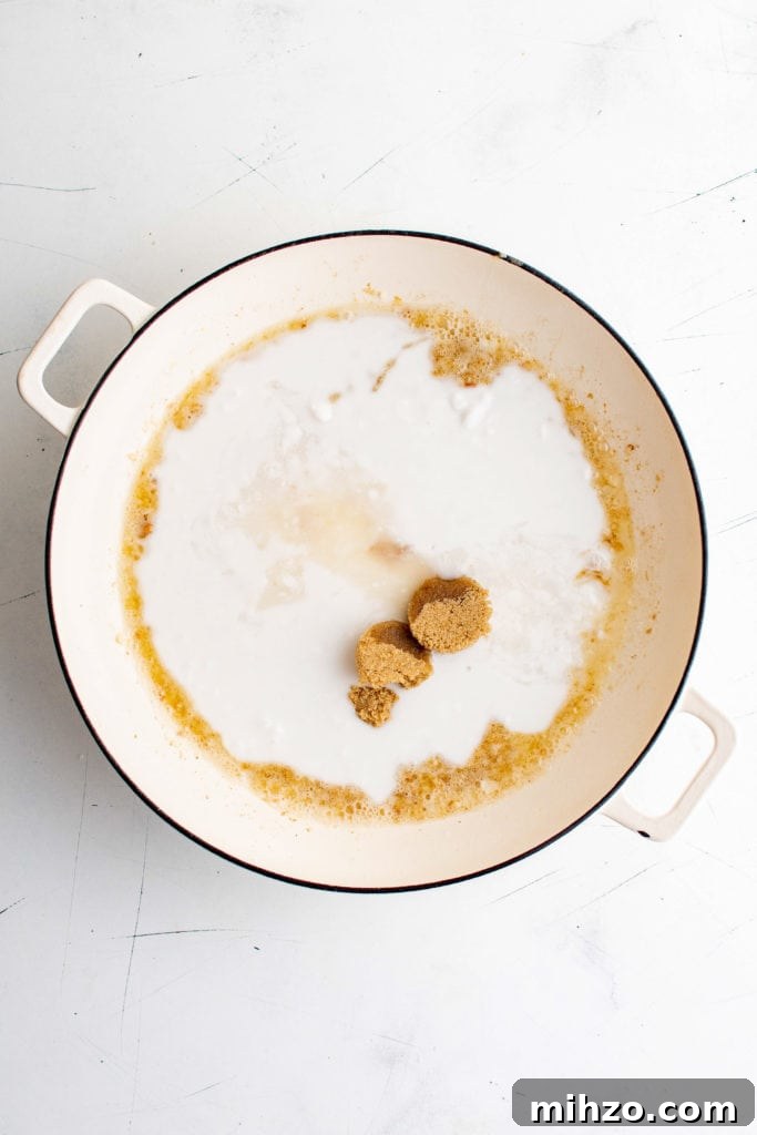 Coconut milk, lime juice and brown sugar added to a pan.