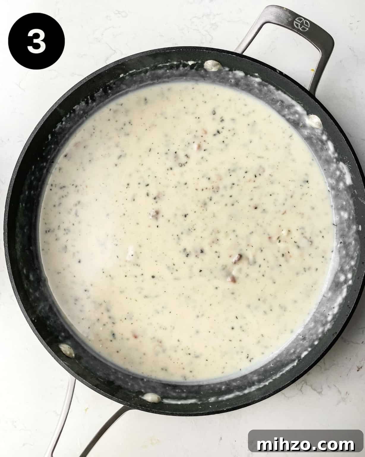 Creamy White Pepper Gravy Recipe for Biscuits and Roast 6 finished white gravy in a pan.