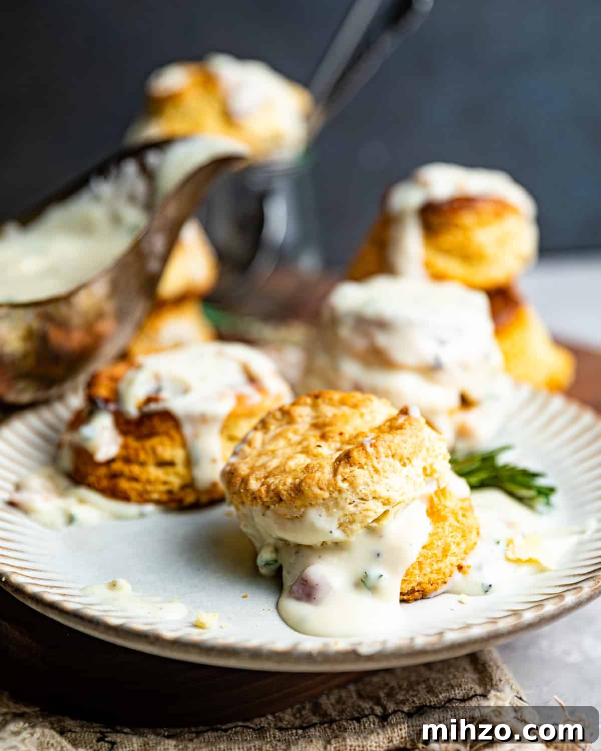 Creamy White Pepper Gravy Recipe for Biscuits and Roast 7 white gravy and biscuits on a plate.