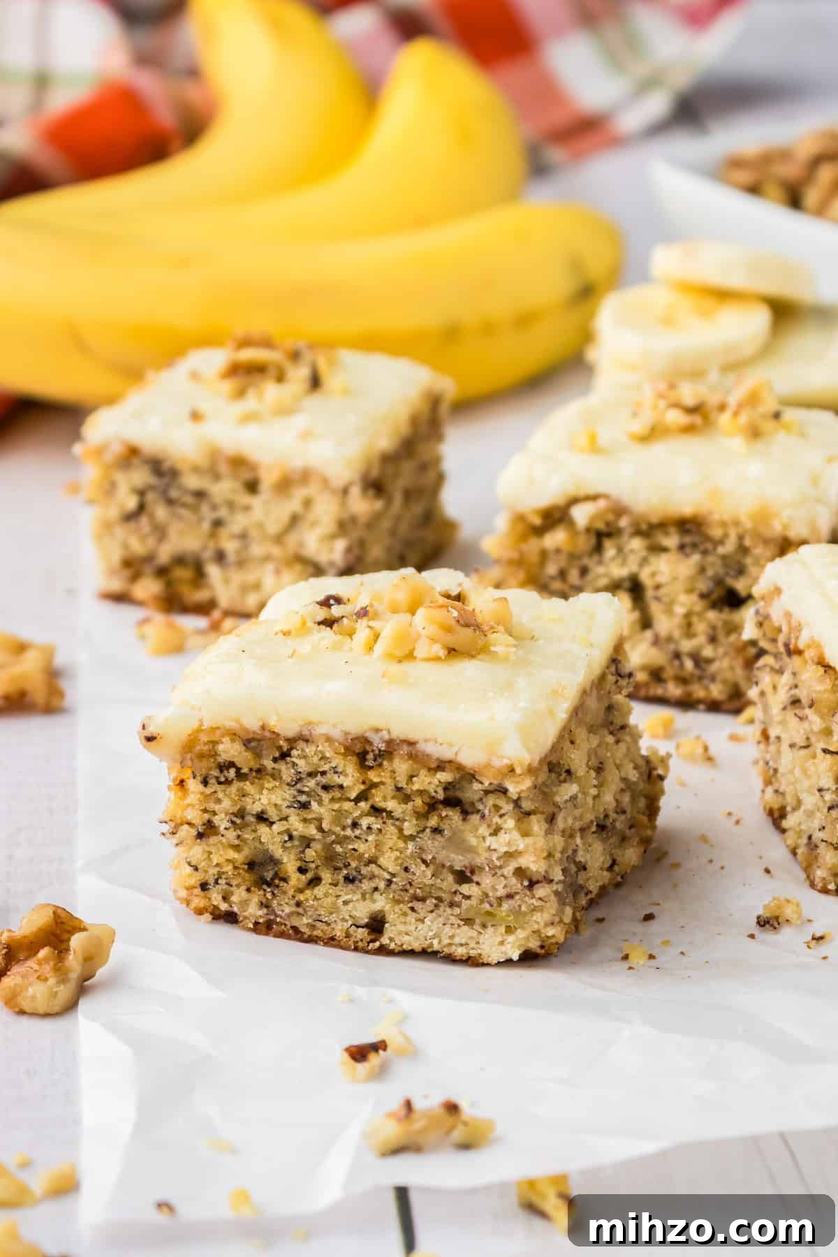 Brown Butter Banana Bread Bars Recipe — Moist Banana Bars 2 A banana bread bar on parchment paper.