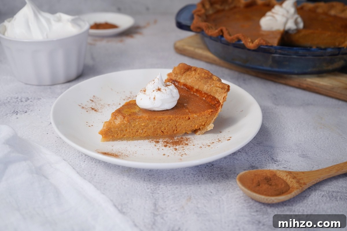 slice of pumpkin pie on white dish
