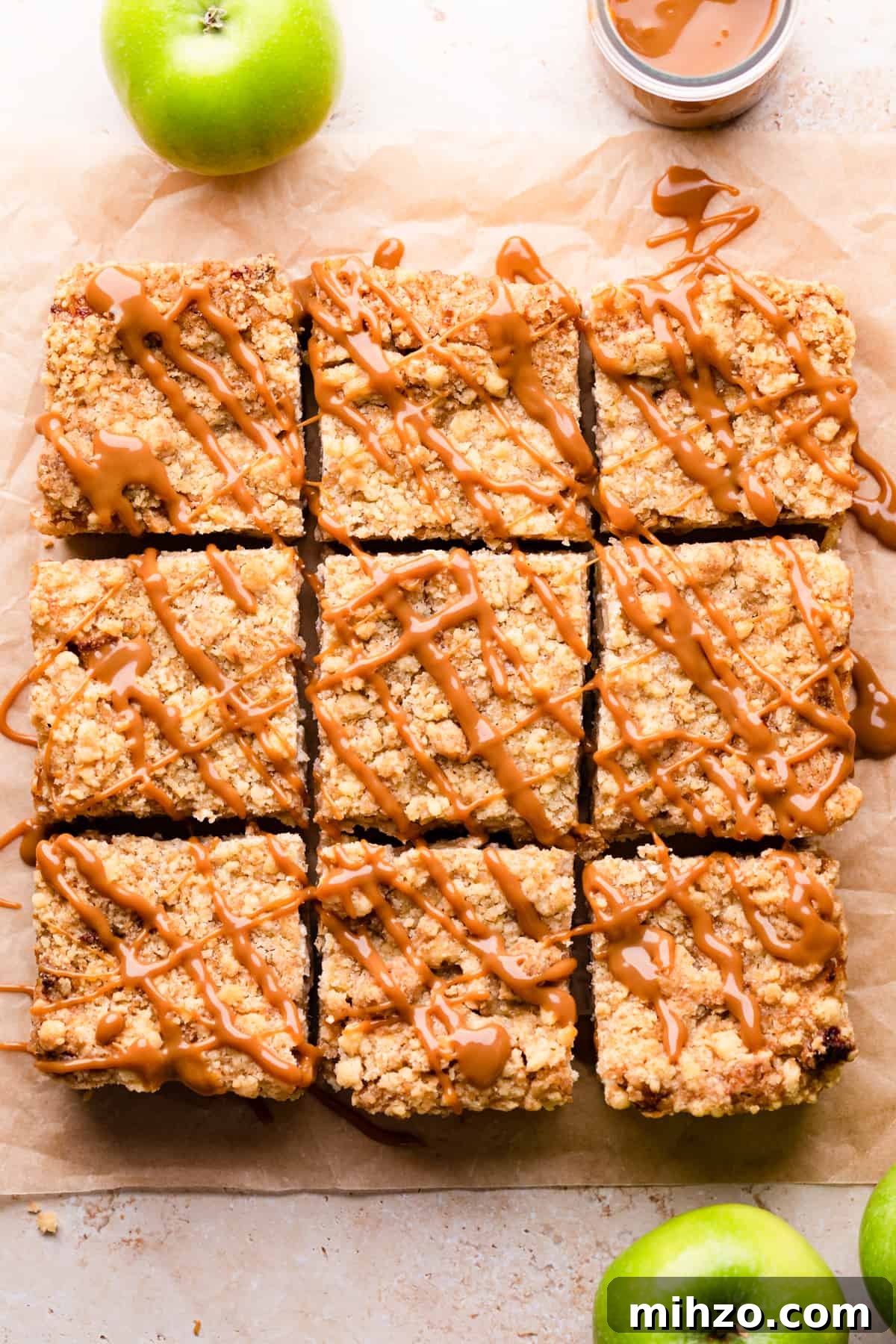 9 slices of caramel apple cheesecake drizzled with caramel sauce.