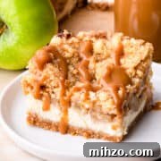 a single square slice of apple caramel cheesecake on a small plate.