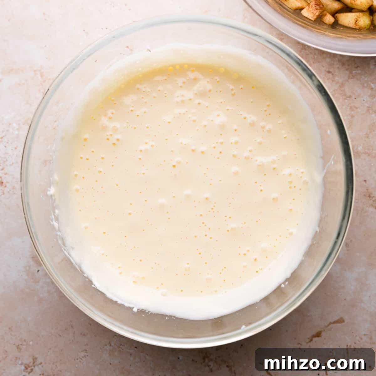 glass bowl with cheesecake batter.