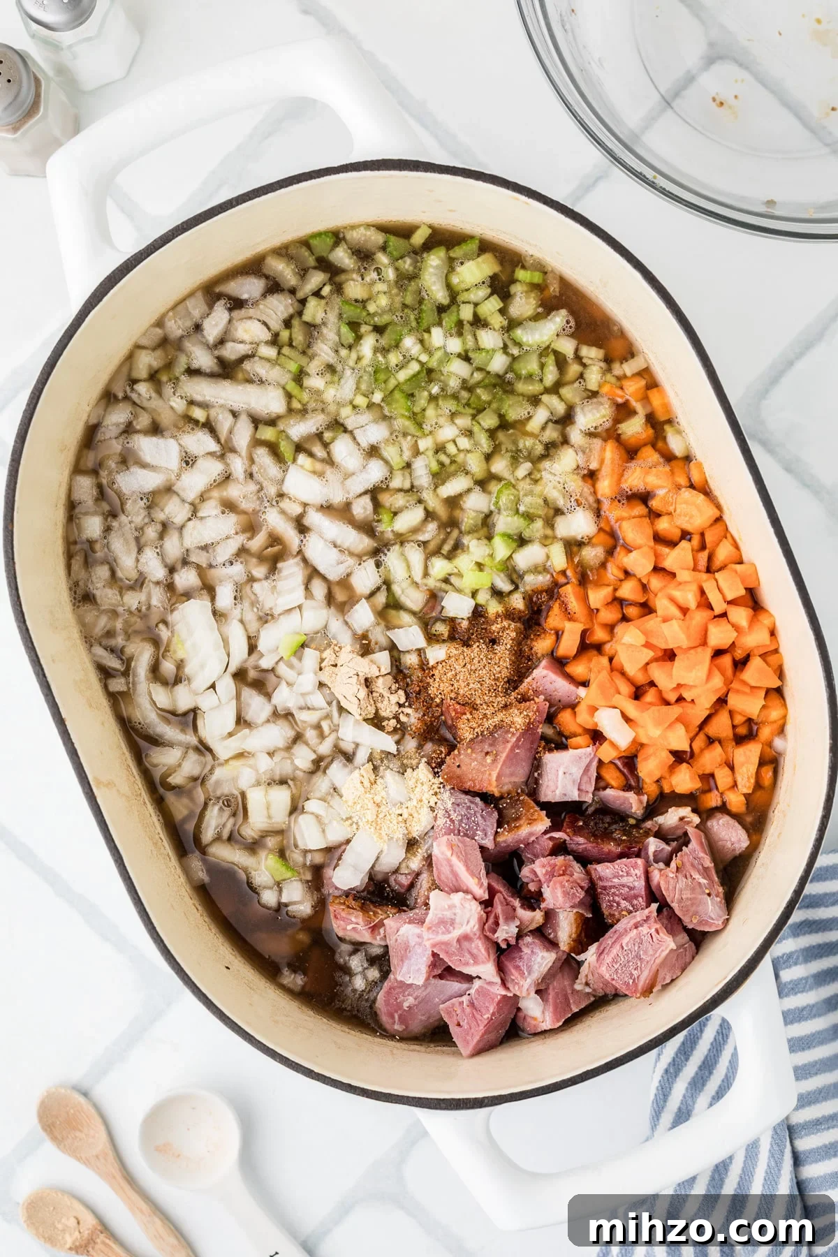 Chopped vegetables floating in broth.