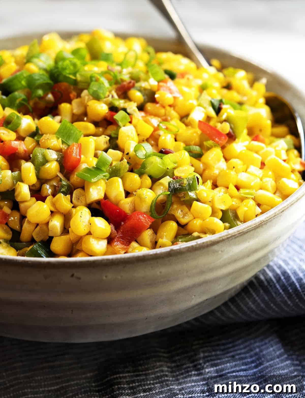 Authentic Cajun Maque Choux Recipe with Sweet Corn and Bacon 2 Corn Maque Choux served in a gray ceramic bowl