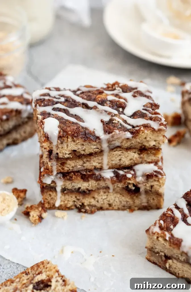 Golden brown banana coffee cake with a brown sugar cinnamon swirl and white icing.