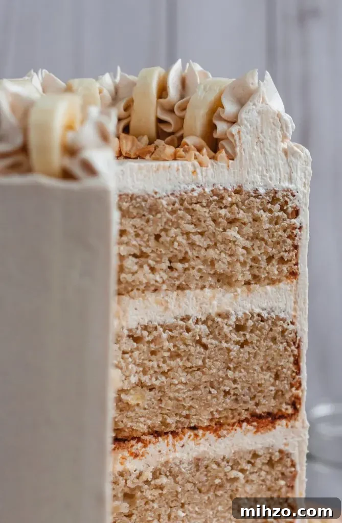 Slice of gluten-free banana layer cake with frosting between layers.