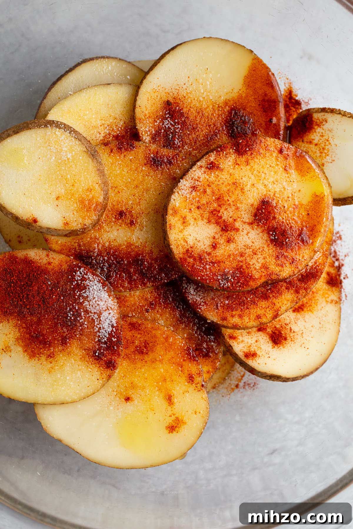 Crispy Air Fryer Sliced Potatoes Recipe 3 Potato slices and seasonings in a bowl
