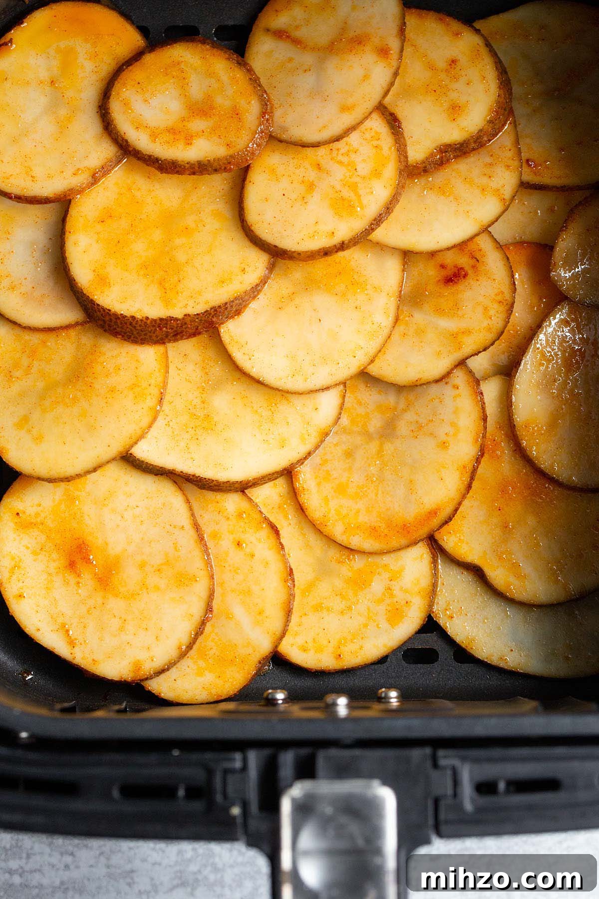 Crispy Air Fryer Sliced Potatoes Recipe 4 Uncooked potato slices in air fryer basket