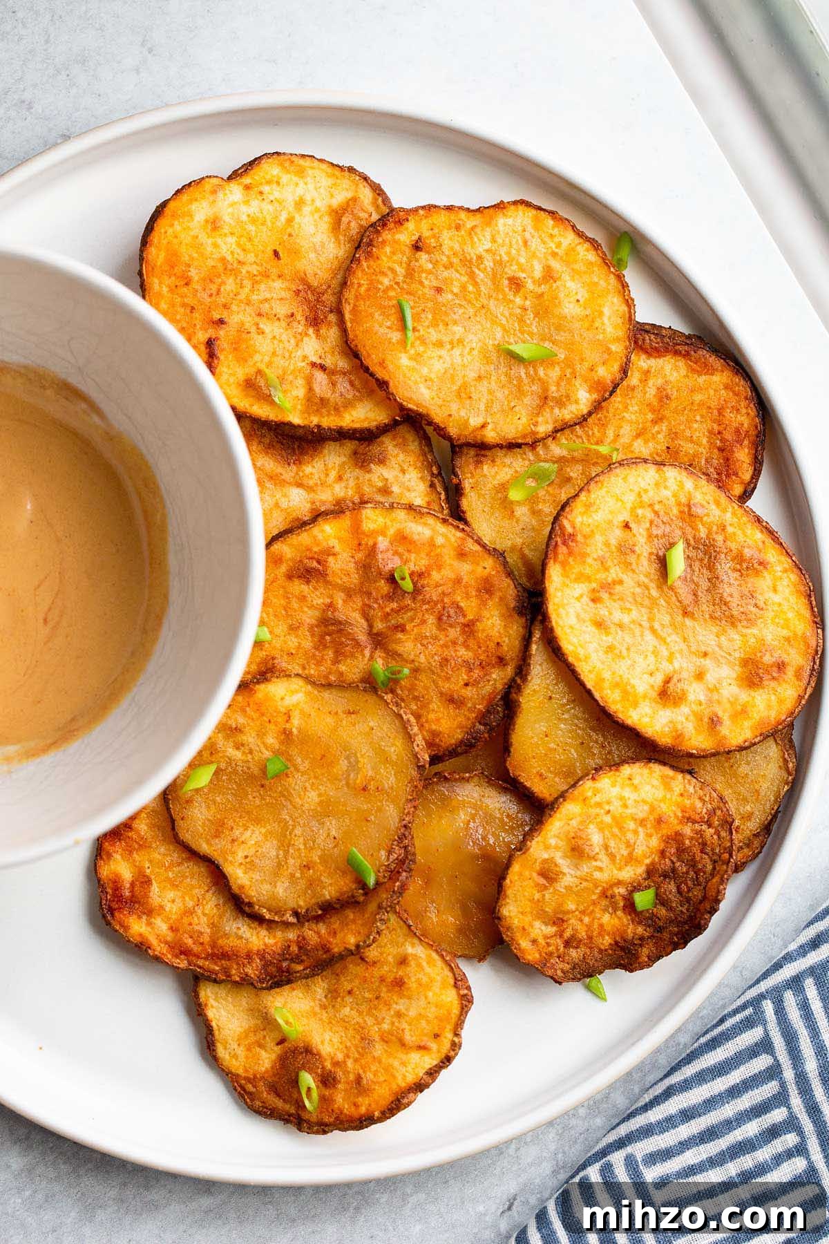 Crispy Air Fryer Sliced Potatoes Recipe 6 Air fryer potato slices with a dipping sauce.