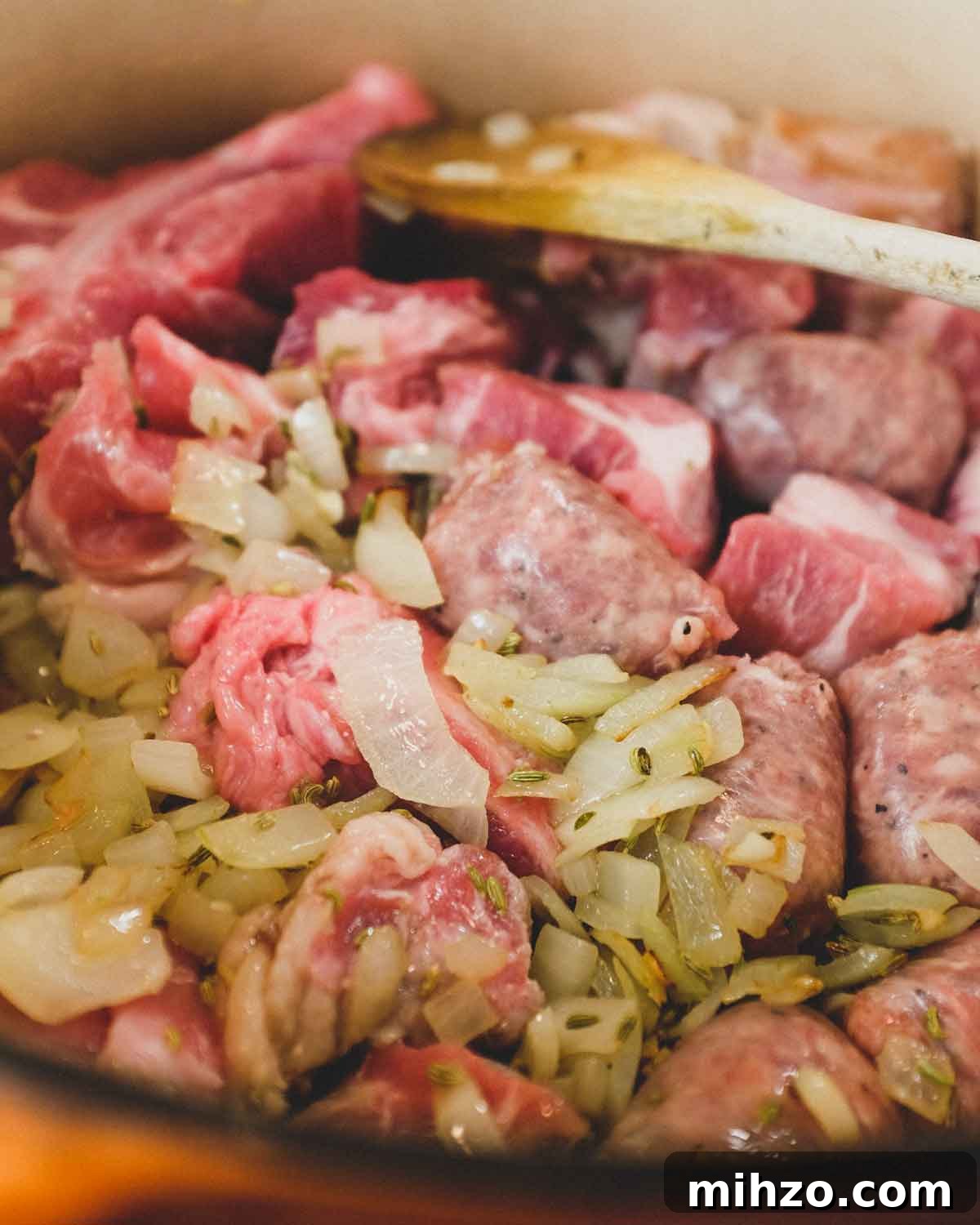 Cavatelli with Pork Ragù | cookeatworld.com Sausage and pork frying in a large pan with onion and herbs