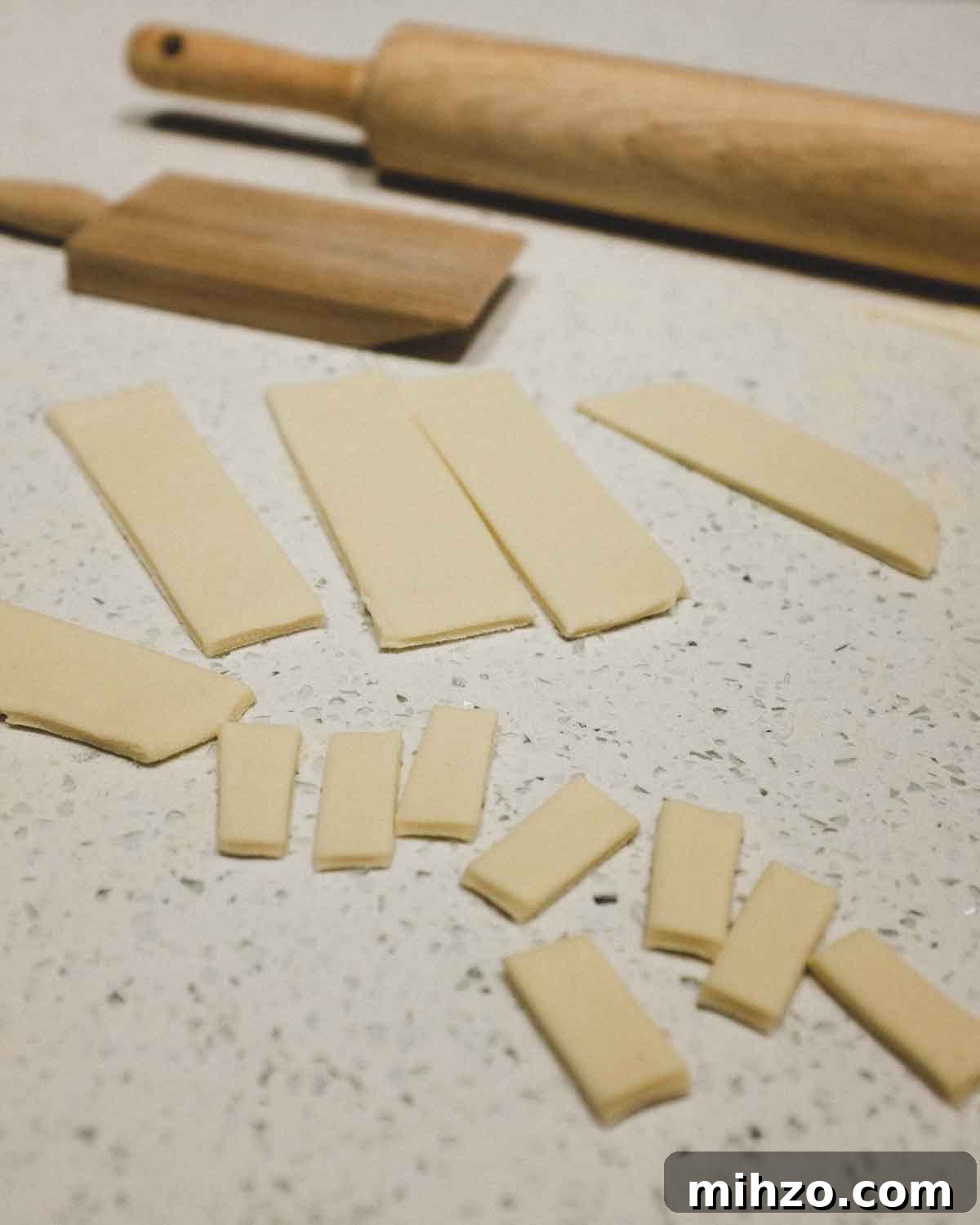 Cavatelli with Pork Ragù | cookeatworld.com cutting fresh pasta into small pieces, ready for rolling into cavatelli shapes.