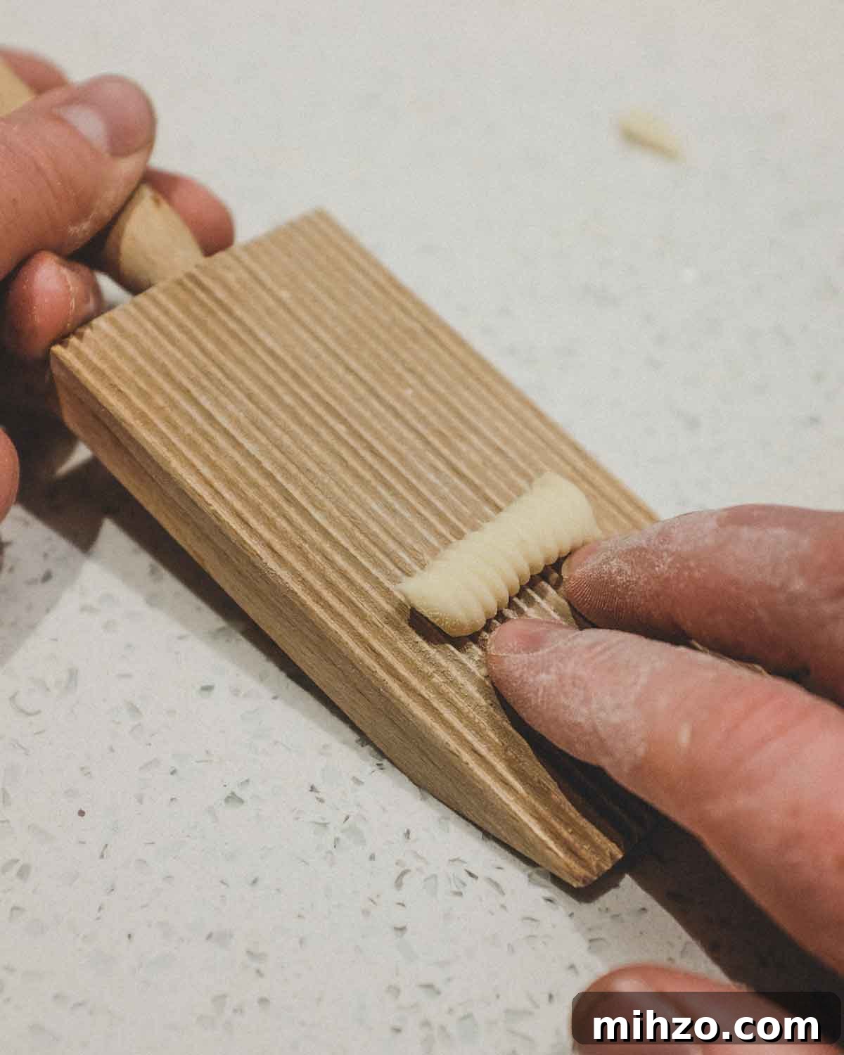 Cavatelli with Pork Ragù | cookeatworld.com Rolling cavatelli pasta on a ridged gnocchi board