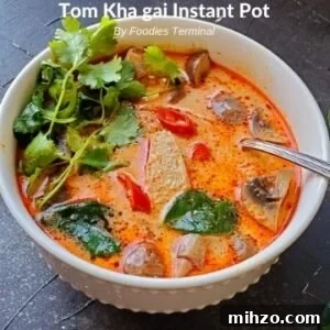 Instant Pot Tom Kha Gai: Creamy Thai Coconut Chicken Soup Recipe 8 Instant Pot Tom Kha Gai in white bowl with spoon
