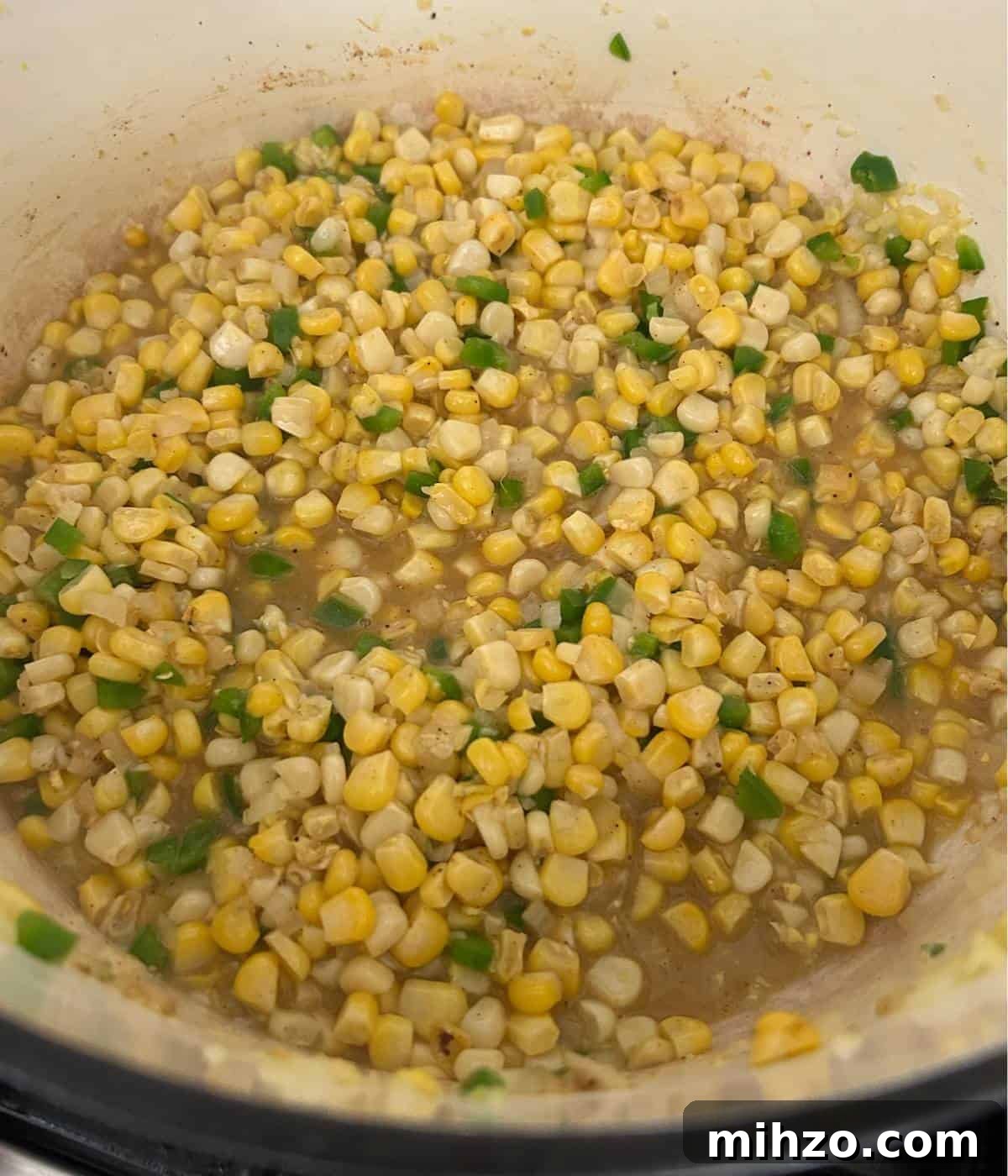 Creamed Corn with Jalapeño: Spicy Southwestern Side Dish 5 Corn with jalapeños in dutch oven.
