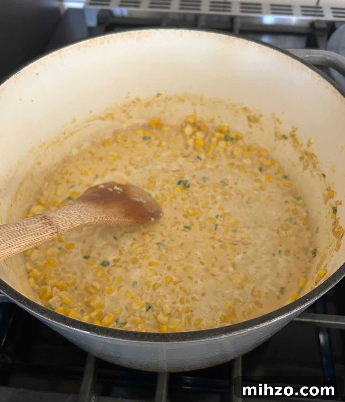 Creamed Corn with Jalapeño: Spicy Southwestern Side Dish 6 Corn and jalapeños cooking in pot.