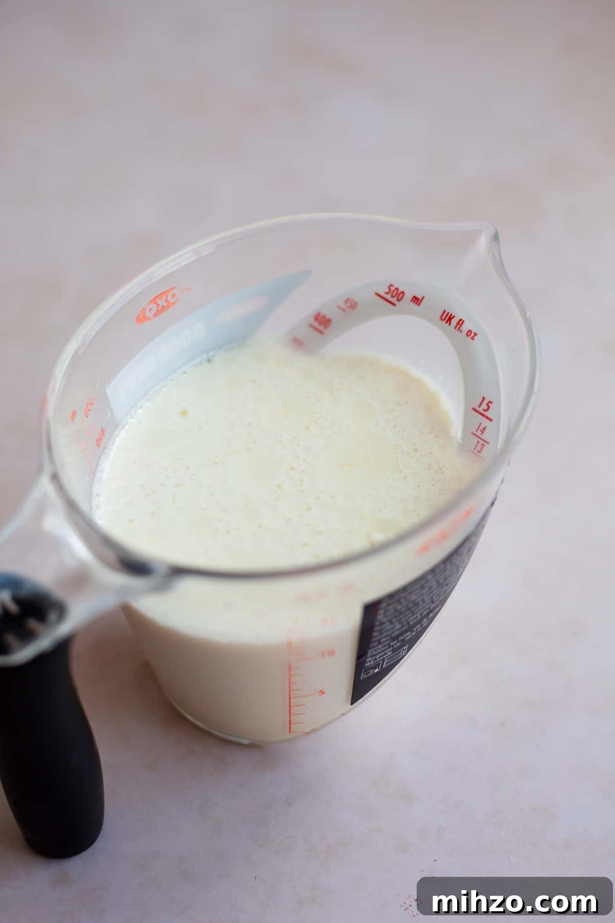 Milk and yoghurt mixed together in a small plastic pyrex jug