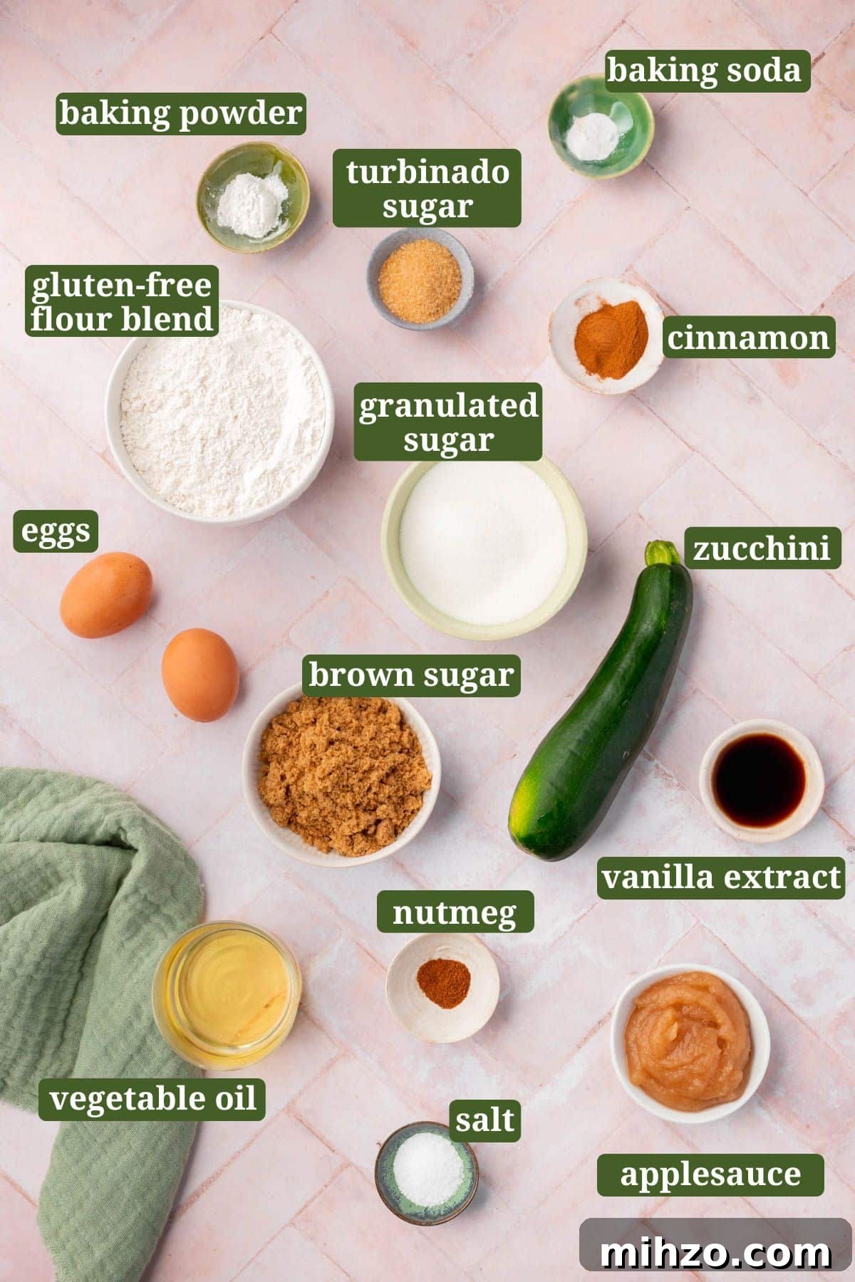 Moist Gluten-Free Zucchini Bread Recipe for Baking Success 3 Ingredients to make gluten-free zucchini bread on a pink table with text overlay over each ingredient.