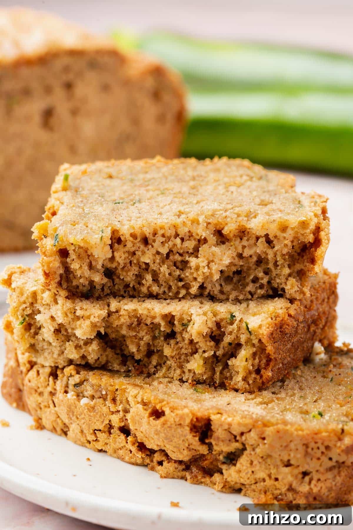 Moist Gluten-Free Zucchini Bread Recipe for Baking Success 5 Three pieces of gluten-free zucchini bread stacked on top of each other.