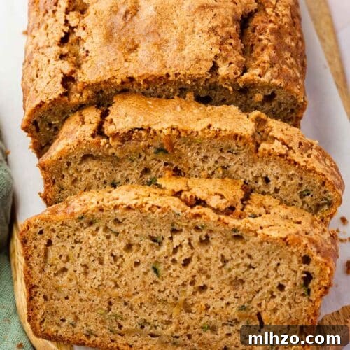Moist Gluten-Free Zucchini Bread Recipe for Baking Success 6 Two slices of gluten-free zucchini bread leaning against the rest of the loaf.