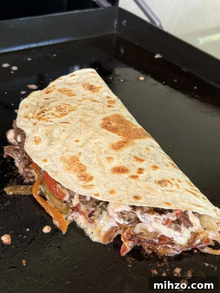 Pepper Steak Quesadillas Recipe: Quick Savory Filled Tortillas 7 tortilla on the griddle with fillings