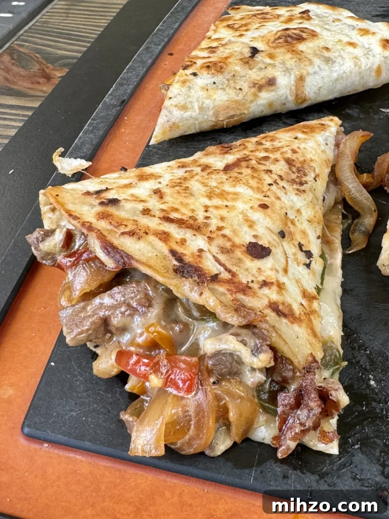 Pepper Steak Quesadillas Recipe: Quick Savory Filled Tortillas 9 up close on a pepper steak quesadilla