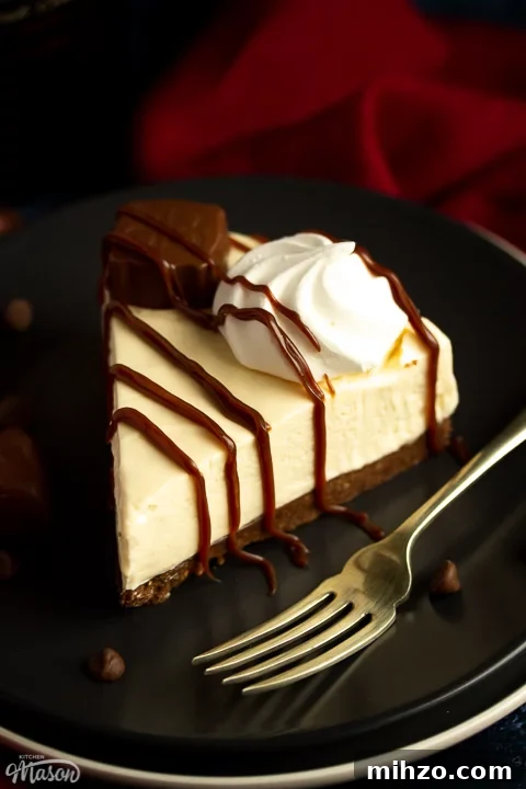 No-Bake Baileys Cheesecake Recipe: Creamy Irish Cream Dessert 3 A slice of no bake Baileys cheesecake on a dark grey plate with a fork