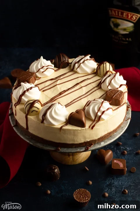 No-Bake Baileys Cheesecake Recipe: Creamy Irish Cream Dessert 15 Baileys cheesecake on a cake stand with chocolates scattered around