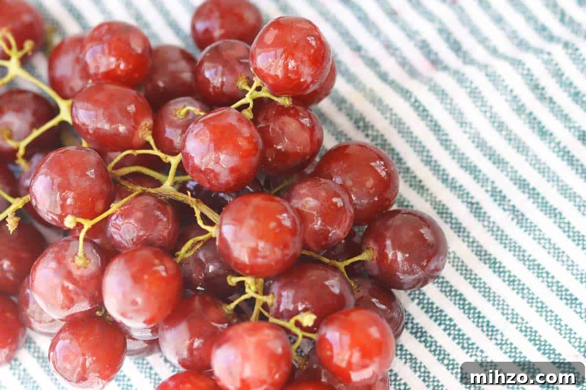 Wash Fruit with Vinegar: DIY Produce Cleaning Spray 5 freshly washed grapes on a striped towel