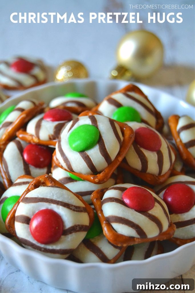 A white dish filled with Christmas pretzel hugs inside