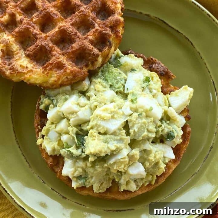 Healthy avocado egg salad made without mayo or yogurt on a chaffle.