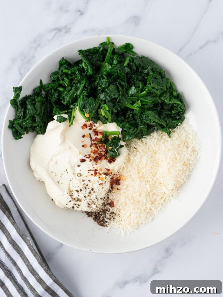 Creamy Spinach-Stuffed Salmon Fillets with Garlic Butter 5 Ingredients for cream cheese filling in a bowl.