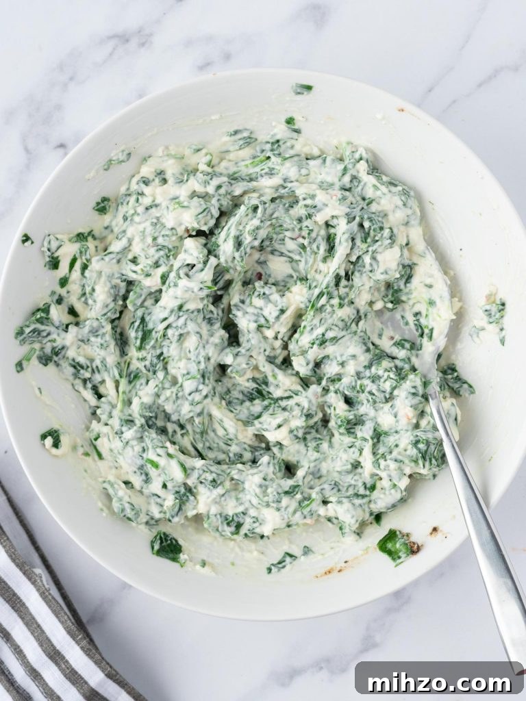 Creamy Spinach-Stuffed Salmon Fillets with Garlic Butter 6 Cream cheese filling mixed in a bowl.