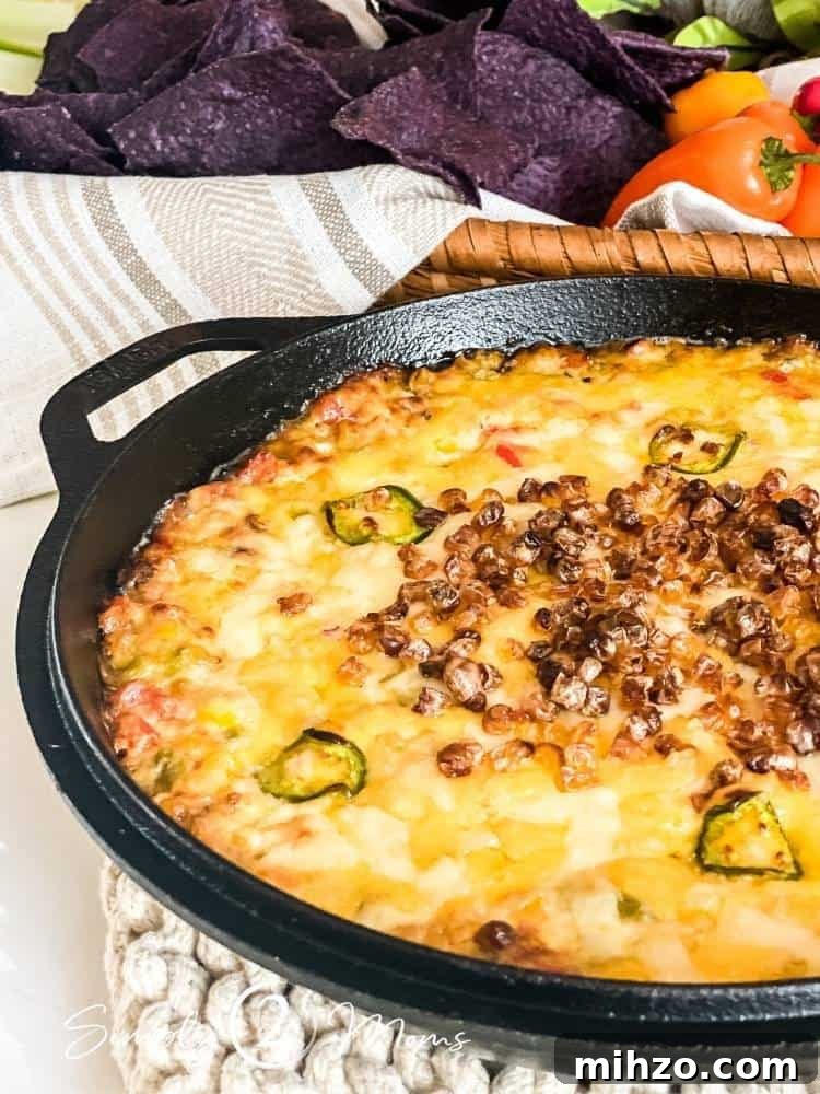 13+ Creative Ways to Make Your Thanksgiving Memorable 13 Roasted hot corn dip in a cast iron skillet with a basket of blue tortilla chips and mini bell peppers